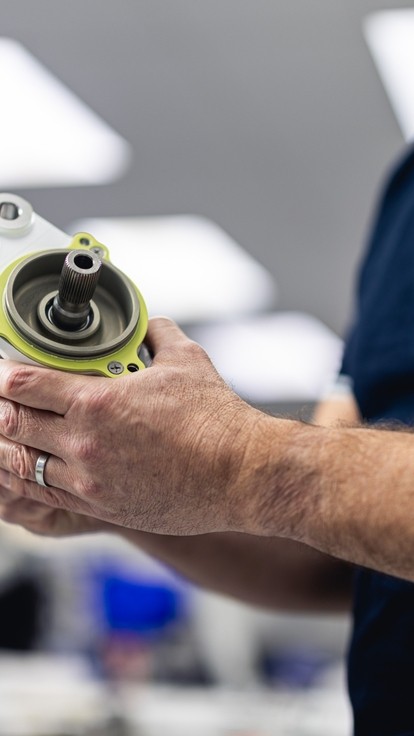 Safran engineer holding a piece of aircraft actuation close up